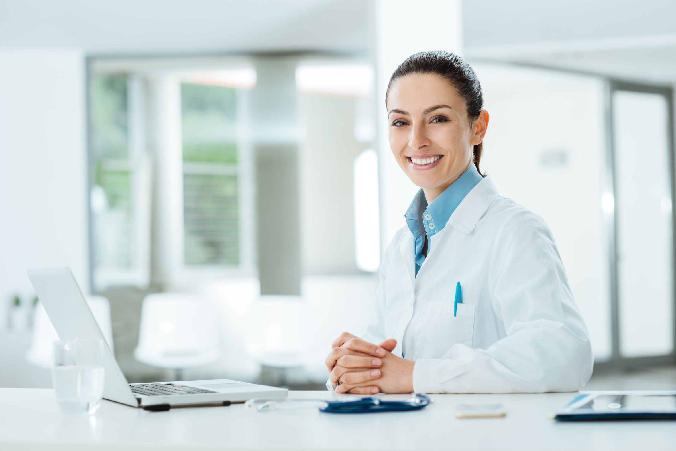 smiling medical doctor on computer